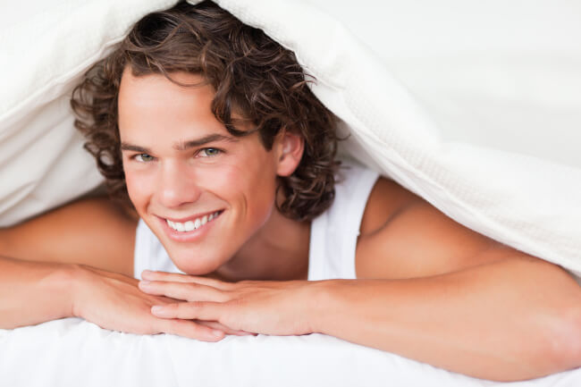 Man smiling in bed
