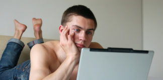 Shirtless man with a computer
