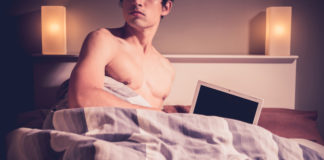 Man in bed with a computer
