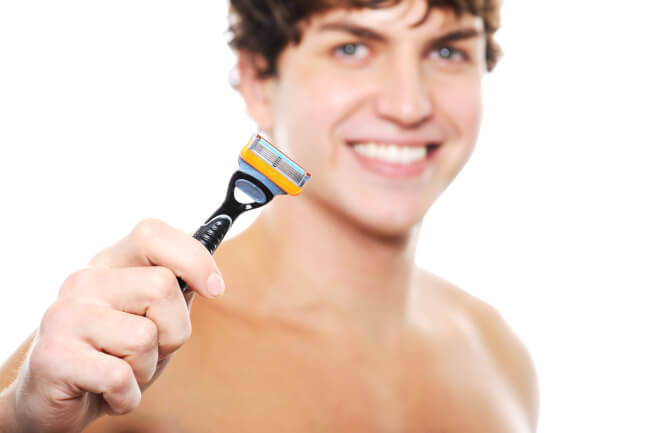 Young man holding a razor