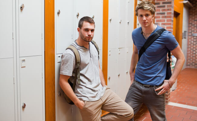 Students with bags in locker room