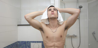 Man drying his hair after a shower