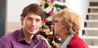 Man with mother and a Christmas tree