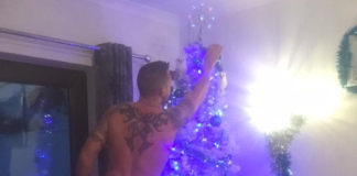 Shaun Welsby setting up Christmas tree naked