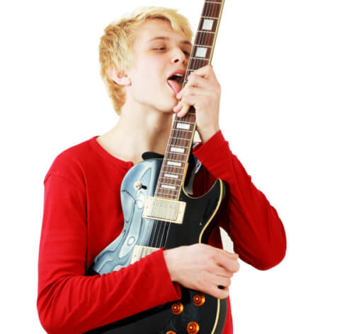 Man licking his guitar with tongue