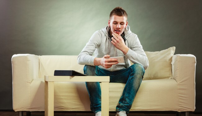 man looking at phone smartphone