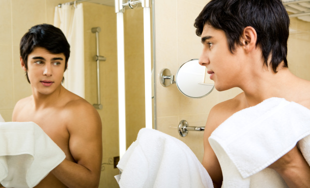 Man in shower in front of mirror